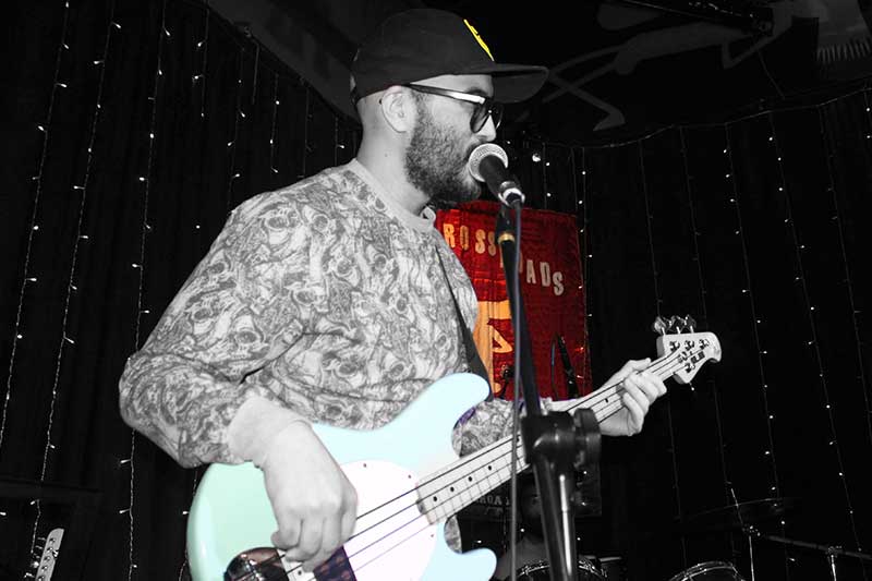 Advanced bass guitar student playing on stage