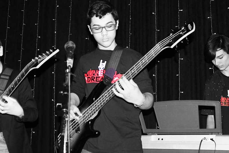 Beginner bass guitar student playing